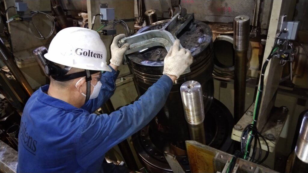 Goltens Engineer removing piston on Wartsila 12V50DF