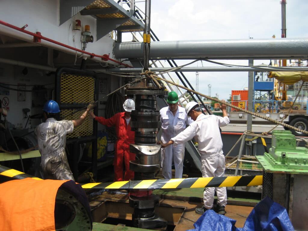 Condemned Bergen diesel crankshaft shaft being rigged off of vessel