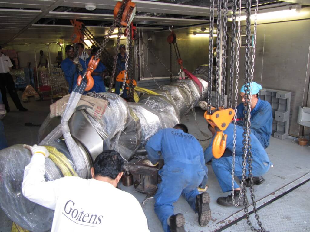 Preparing crankshaft for transport down passageway via skid