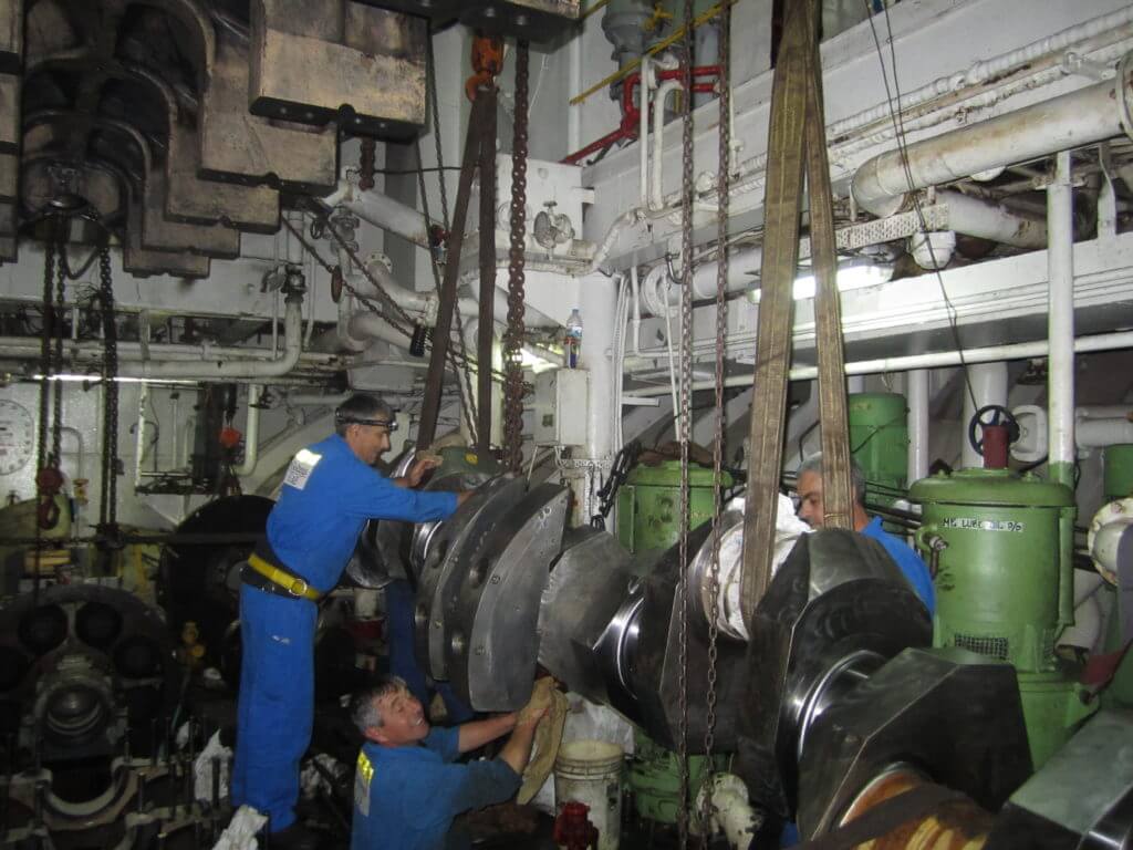 Rigging replacement crankshaft into the engine room for installation