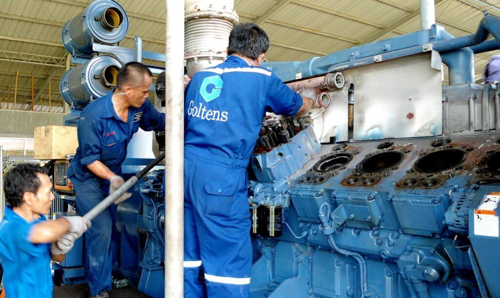 Technicians disassembling the engine