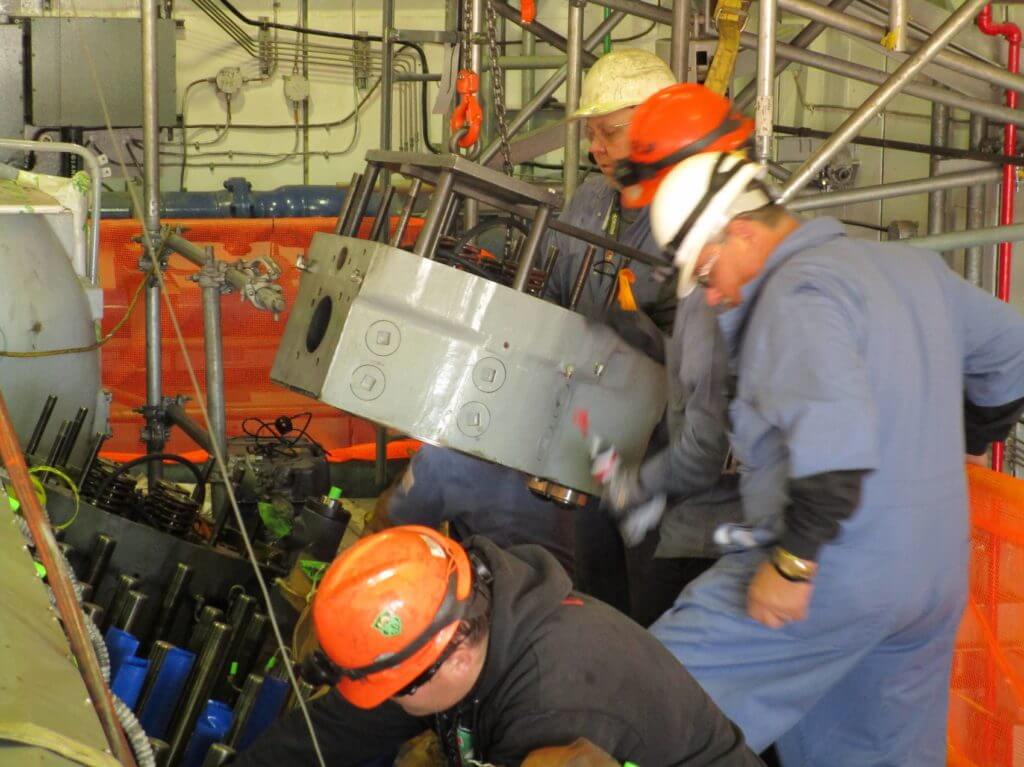 Installation of cylinder heads on Cooper Bessemer emergency diesel prior to testing