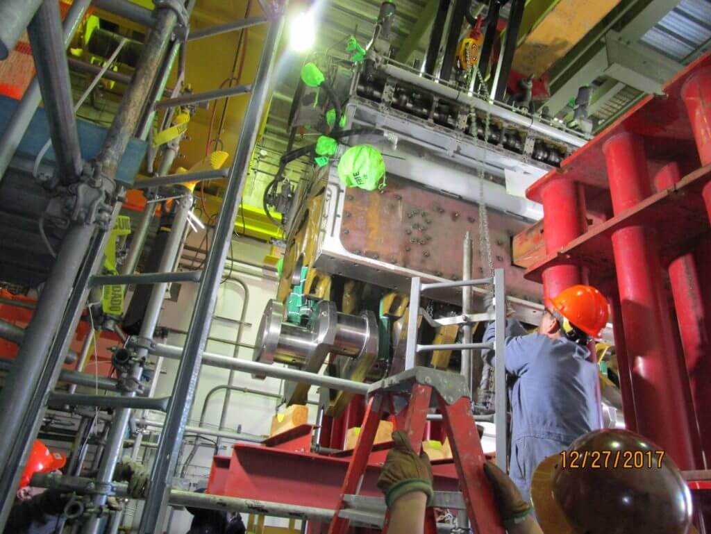 Lowering Cooper Bessemer crankshaft onto skid for removal