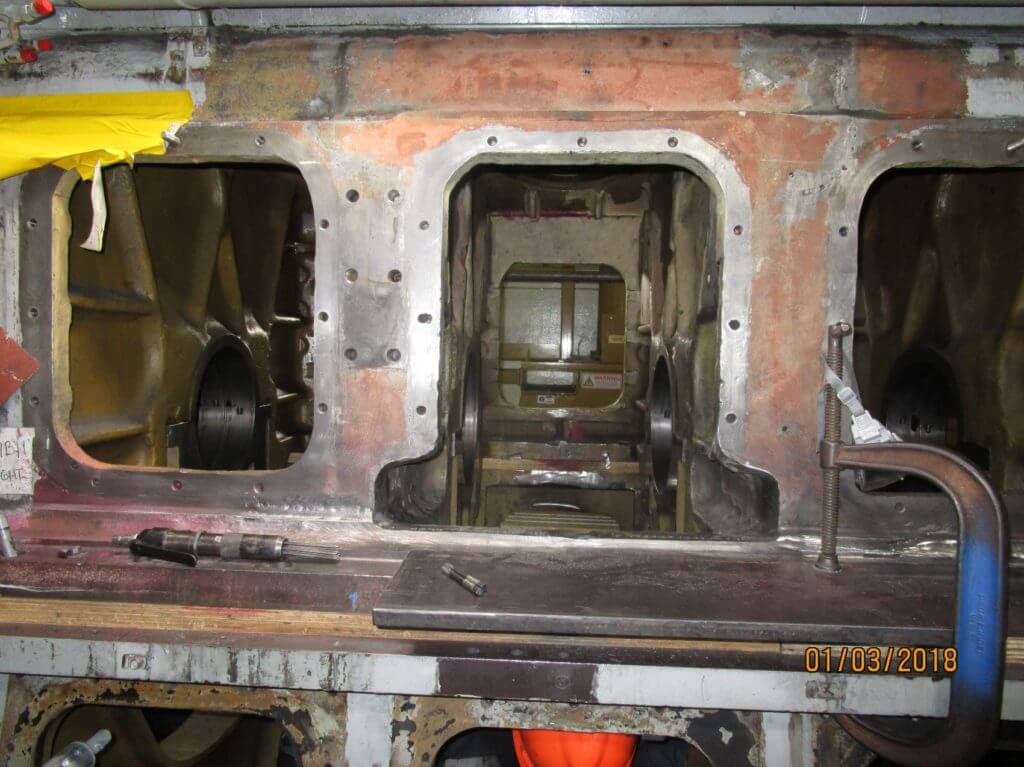 Damaged engine block section removed prior to metallock cast iron repair