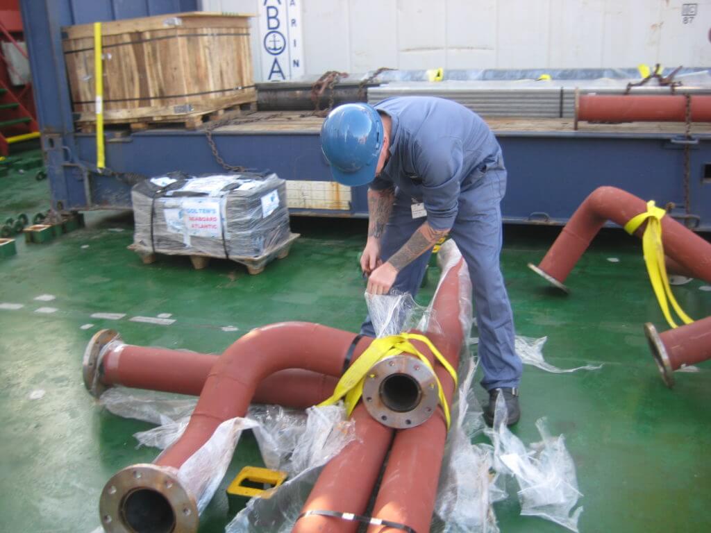 Goltens Engineer unwrapping prefabricated pipes onboard for Hyde BWT retrofit