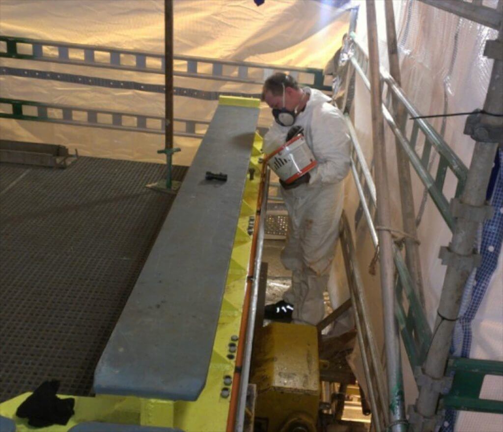 Goltens technician pouring Chockfast Orange compound into foundation mold